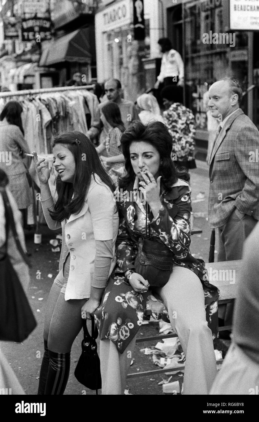 1970s teenage young women smoking cigarettes looking fashionable. 70s fashion street market Beauchamp Place London 1971 UK  HOMER SYKES Stock Photo