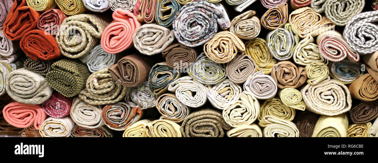 rolls of fabrics on the shelves of the haberdashery Stock Photo Alamy