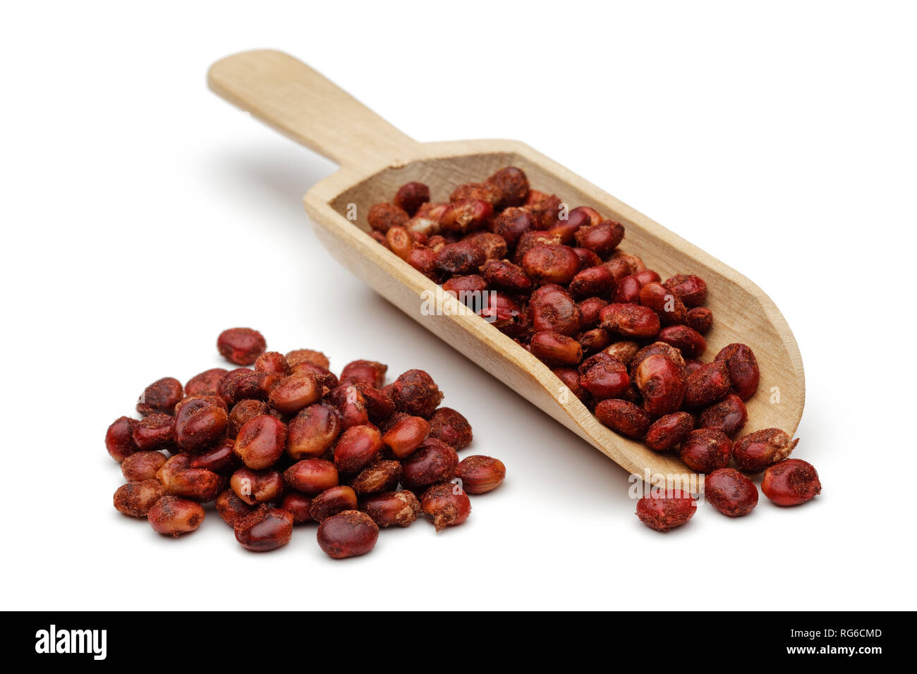 Dried sumac berries in wooden scoop, isolated on white background Stock