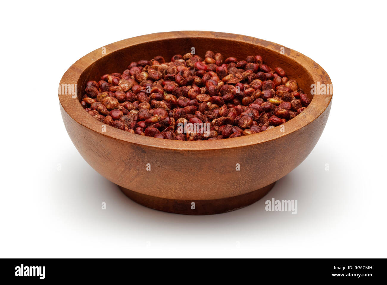 Dried sumac berries in wooden bowl, isolated on white background Stock