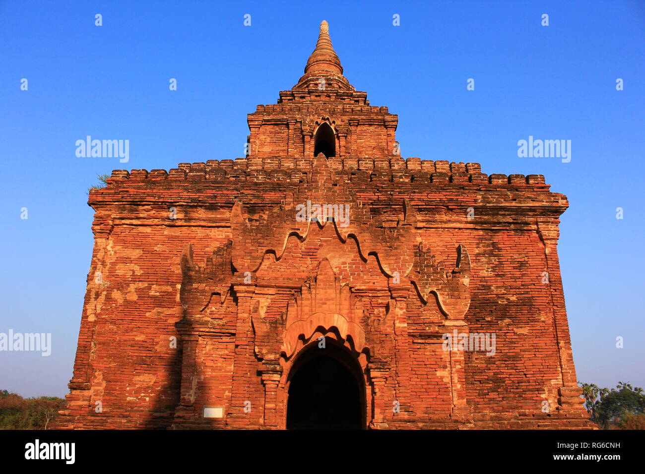 Bagan temple in with a clear blue morning sky in the hot first morning sun of the day in Bagan, Myanmar Stock Photo