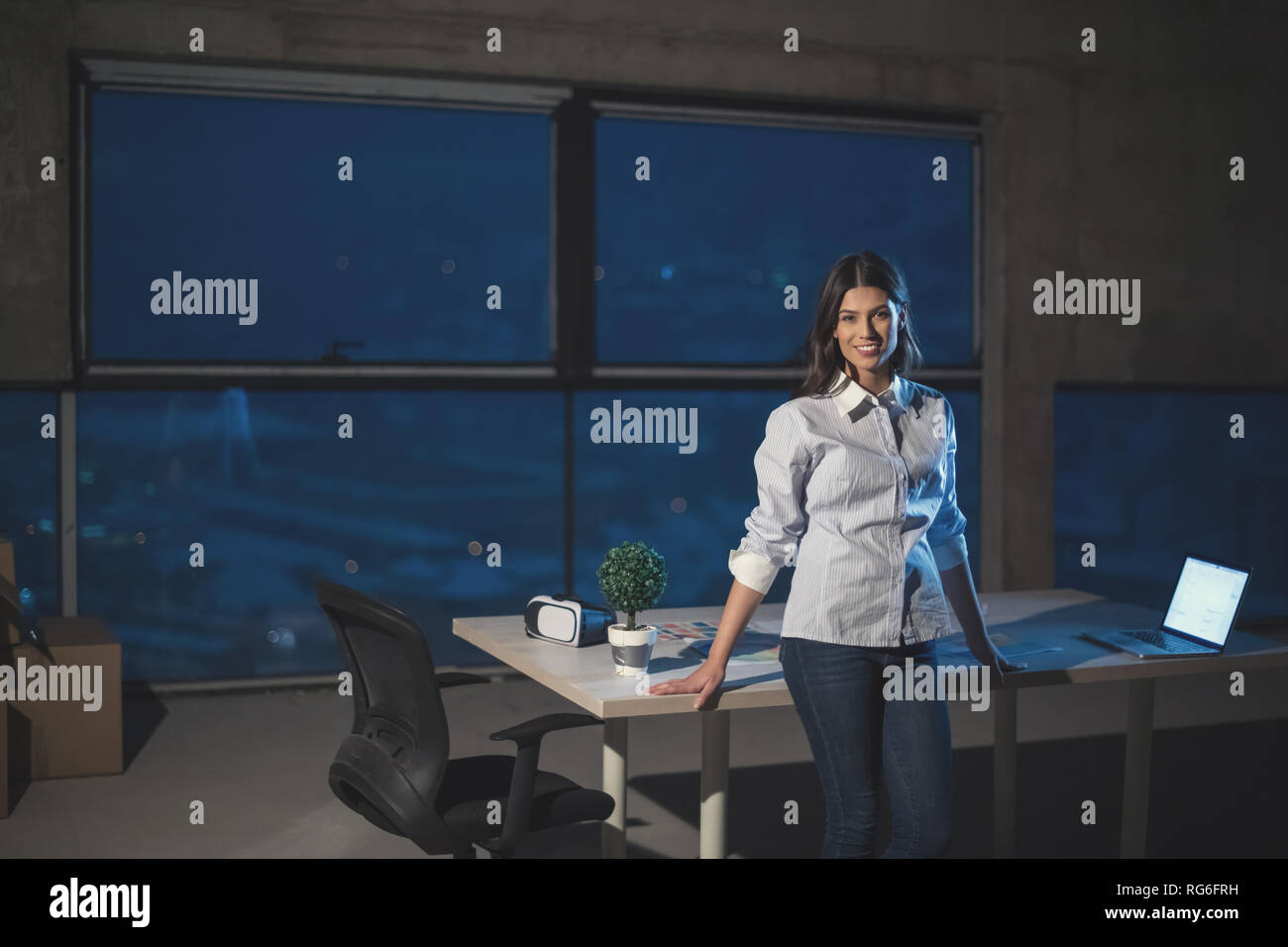 portrait of young female architect on construction site checking documents and business workflow using laptop computer in new startup office Stock Photo