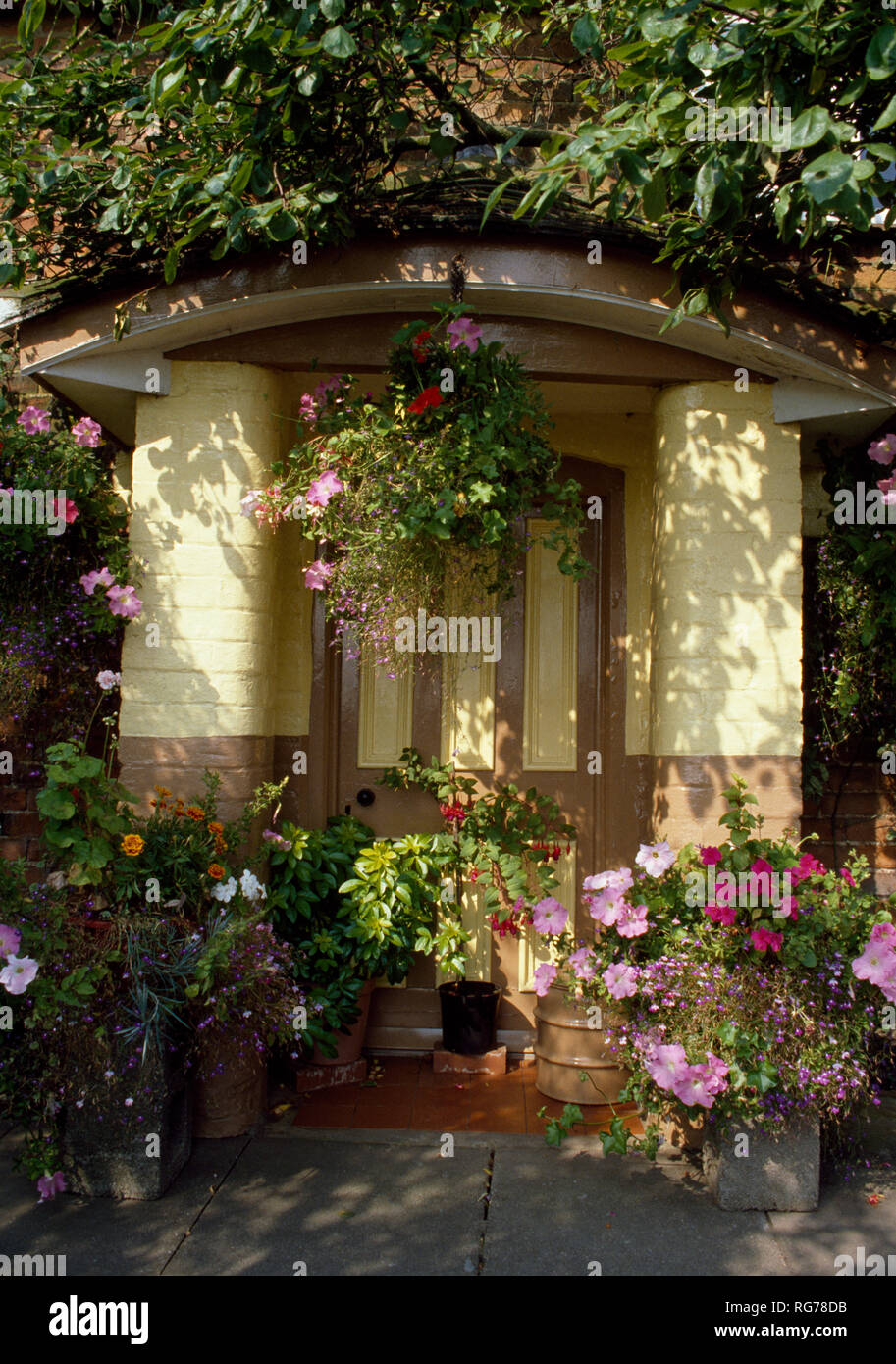 Colourful Annuals In Pots And Hanging Baskets Around Front Door