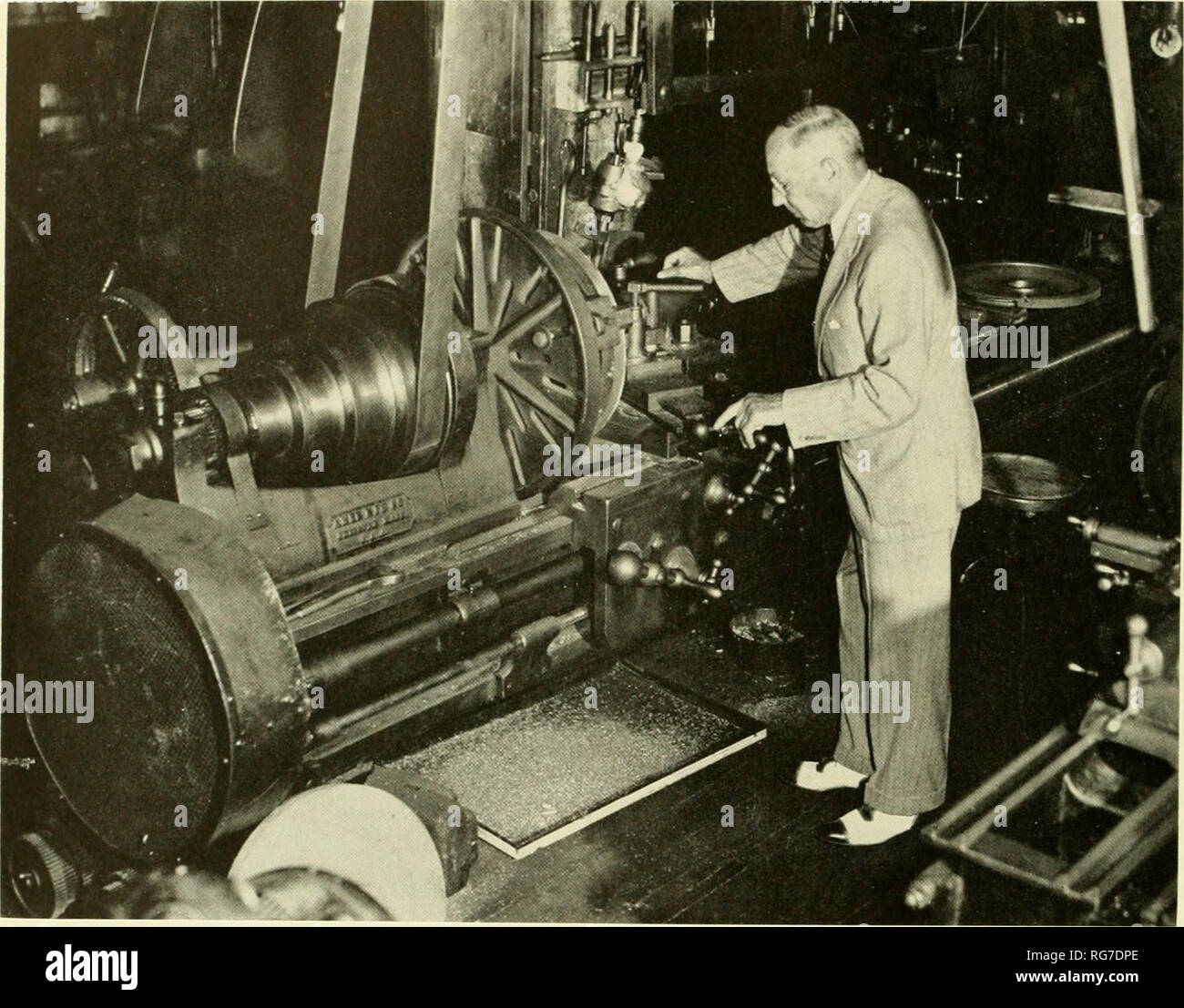 . Bulletin - United States National Museum. Science. Figure 13.—J. Frank Duryea looking over the Russell shop lathe on which he turned parts for the first Duryea vehicle. Photo taken about 10,44. (Courtesy of the Springfield Union.) bicycles in the same area, but who occasionally assisted on the carriage. Russell Company records show time charged against Charles Duryea by six other Russell employees: W. J. Russell, P. Colgan, C. E. Merrick, T. Shea, L. J. Parmelee, and A. A. Poissant. It is Frank Duryea's remembrance that he started work on Monday, April 4. He first removed the body, with its  Stock Photo