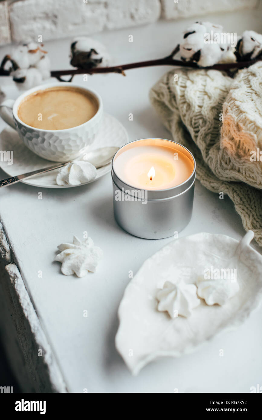 Cozy winter home interior with knitted blanket and candle Stock Photo