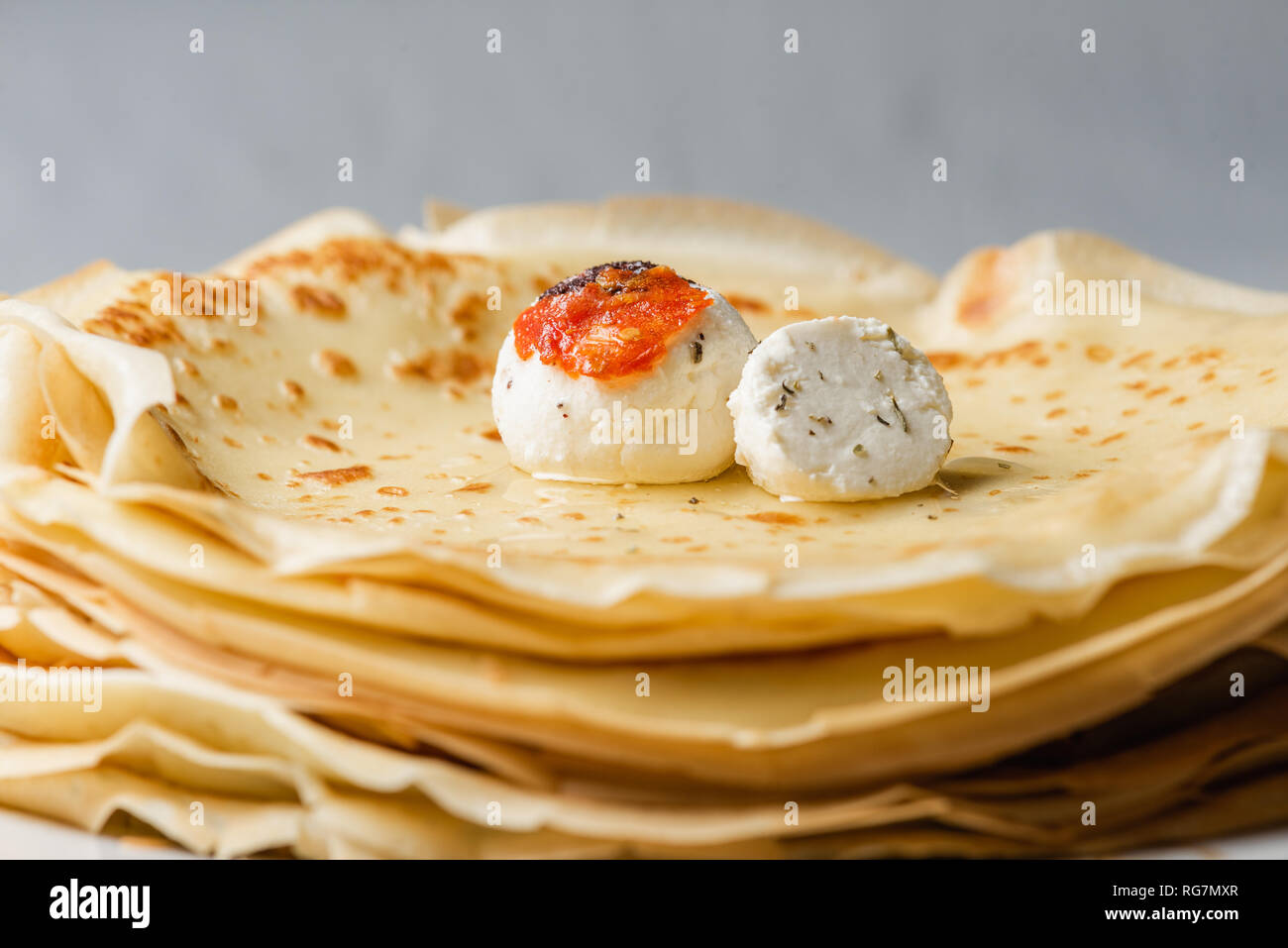 Russian style thin pancakes with homemade cheese balls Stock Photo