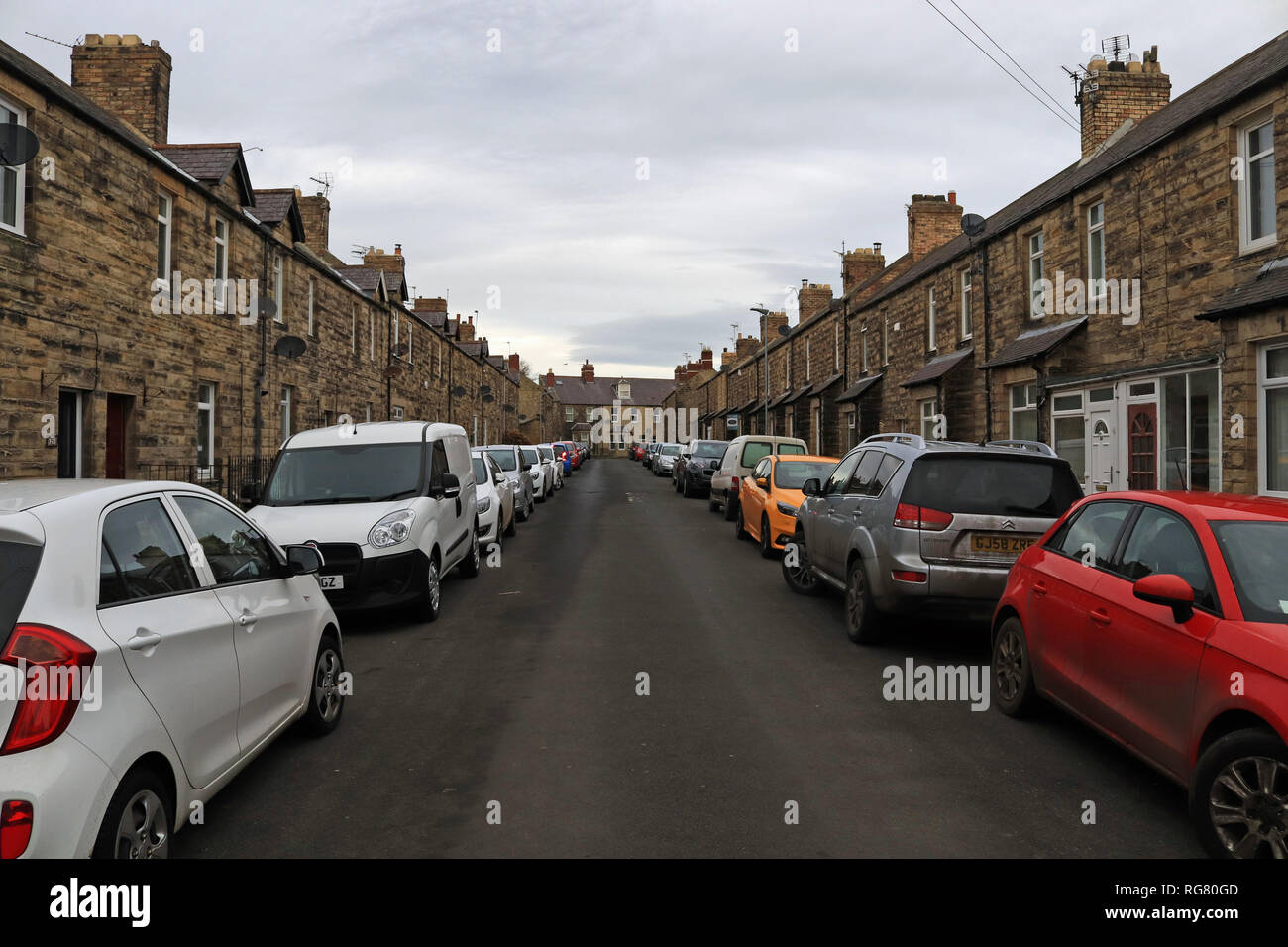 Parking down both sides of the street hires stock photography and