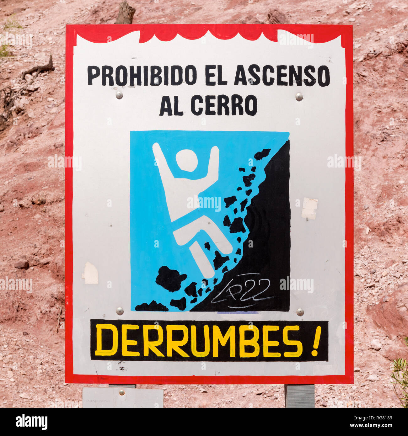 A sign, in Spanish, warning of the dangers of climbing the hill of seven colours.  Picture taken in the village of Purmamarca, Northern Argentina. Stock Photo