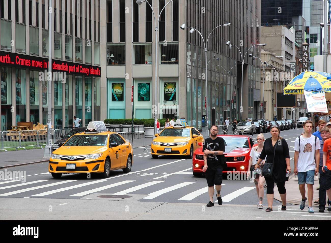 NEW YORK, USA - JULY 4, 2013: People walk along 6th Avenue in New York. Almost 19 million people live in New York City metropolitan area. Stock Photo