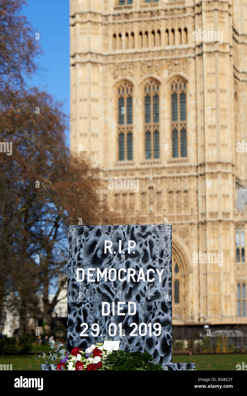 London, UK. - 28 Jan 2019: A tombstone saying RIP democracy is symbolically placed in front of Parliament before a vote on Theresa May's deal in Parliament. Credit: Kevin J. Frost/Alamy Live News Stock Photo