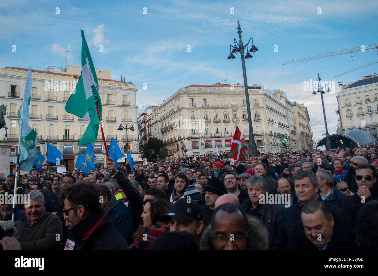 Madrid, Spain. 28th January 2019. Taxi drivers in Madrid have been on a strike for more than a week demanding the prohibition of Uber and Cabify in the Spanish capital-city.   Due to a lack of agreement, hundreds of taxi drivers protested at Puerta del Sol, Madrid’s central square. Credit: Lora Grigorova/Alamy Live News Stock Photo