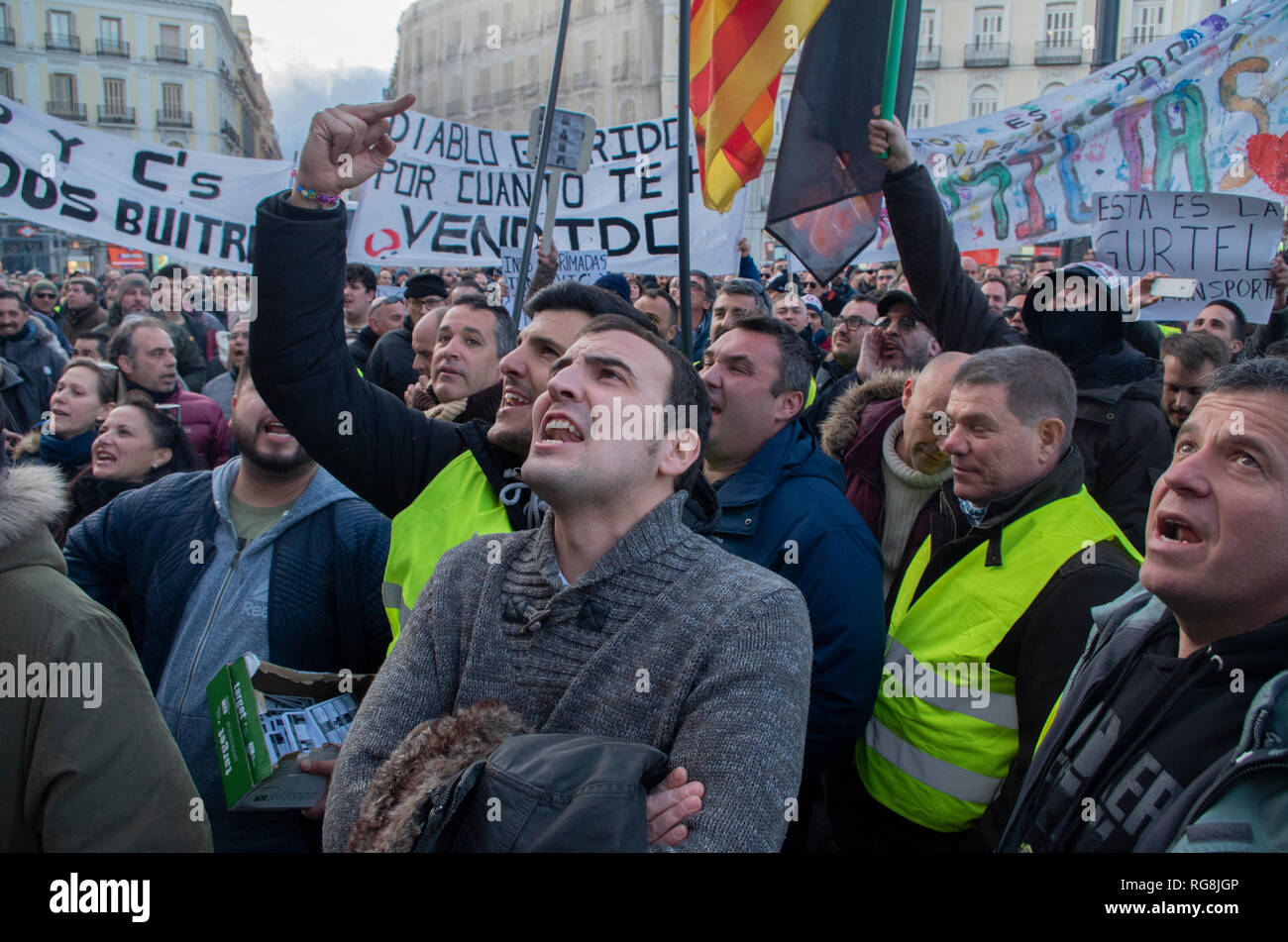 Madrid, Spain. 28th January 2019. Taxi drivers in Madrid have been on a strike for more than a week demanding the prohibition of Uber and Cabify in the Spanish capital-city.   Due to a lack of agreement, hundreds of taxi drivers protested at Puerta del Sol, Madrid’s central square.  In the picture taxi drivers are angrily protesting. Credit: Lora Grigorova/Alamy Live News Stock Photo