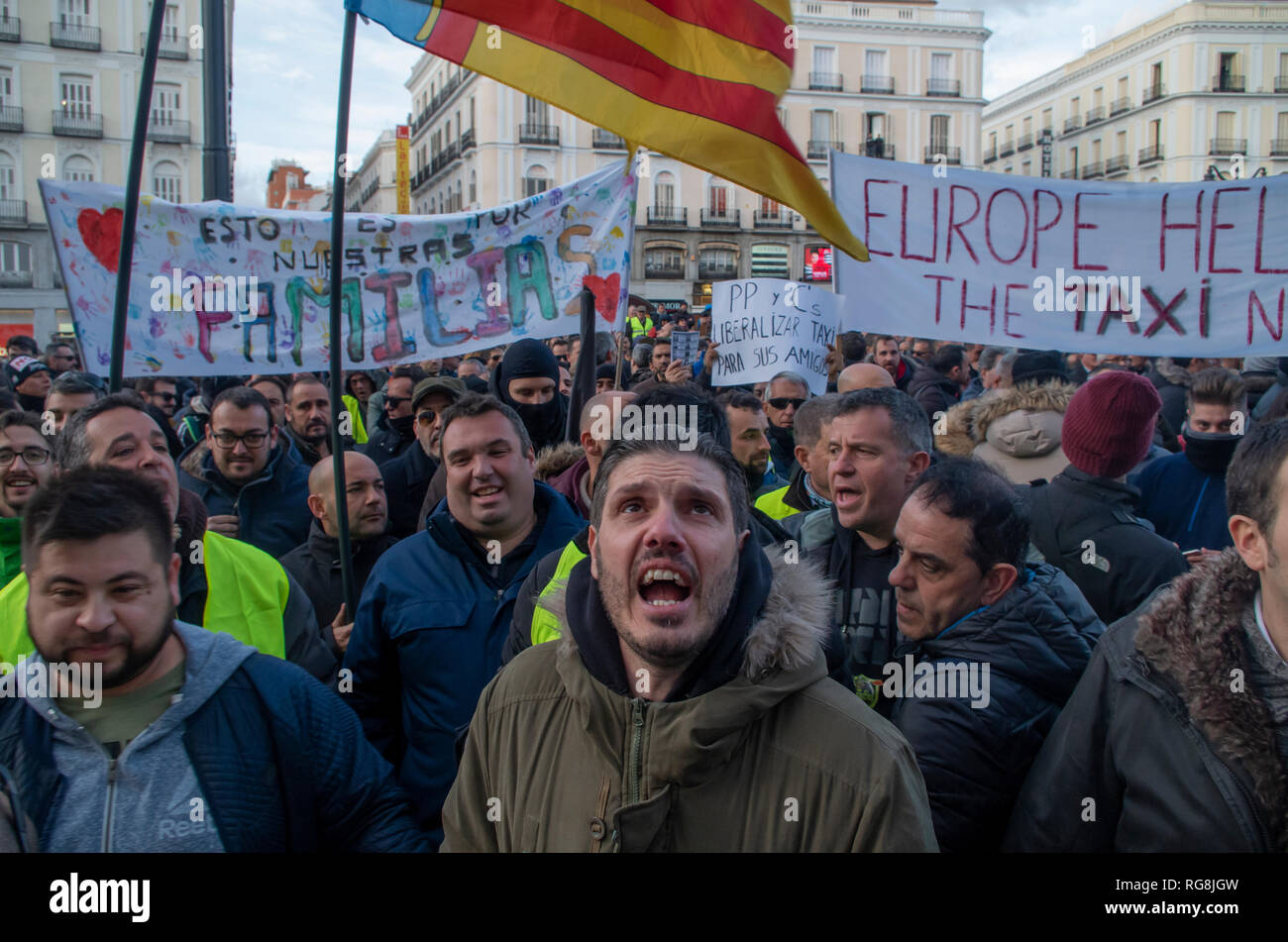Madrid, Spain. 28th January 2019. Taxi drivers in Madrid have been on a strike for more than a week demanding the prohibition of Uber and Cabify in the Spanish capital-city.   Due to a lack of agreement, hundreds of taxi drivers protested at Puerta del Sol, Madrid’s central square.  In the picture a taxi driver in protesting angrily in the middle of the crowd. Credit: Lora Grigorova/Alamy Live News Stock Photo