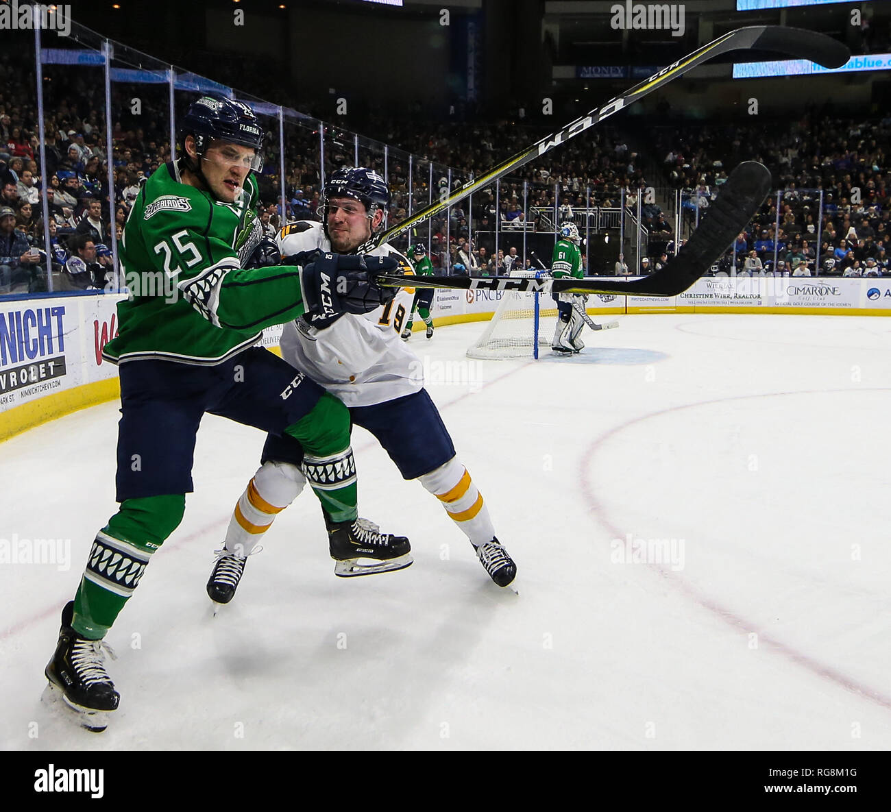 Florida Everblades forward John McCarron (25) checked by Jacksonville Icemen forward Cody Fowlie (19), right, during the first period of an ECHL professional hockey game at the Veterans Memorial Arena in Jacksonville, Fla., Saturday, Jan. 26, 2019. (Gary Lloyd McCullough/Cal Sport Media) Stock Photo