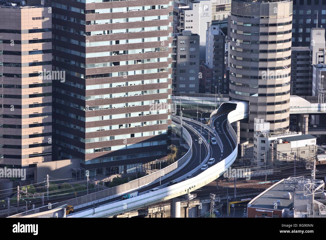 OSAKA, JAPAN - APRIL 27: Cars ride through Gate Tower Building on April 27, 2012 in Osaka, Japan. The building is extremely popular because of highway Stock Photo
