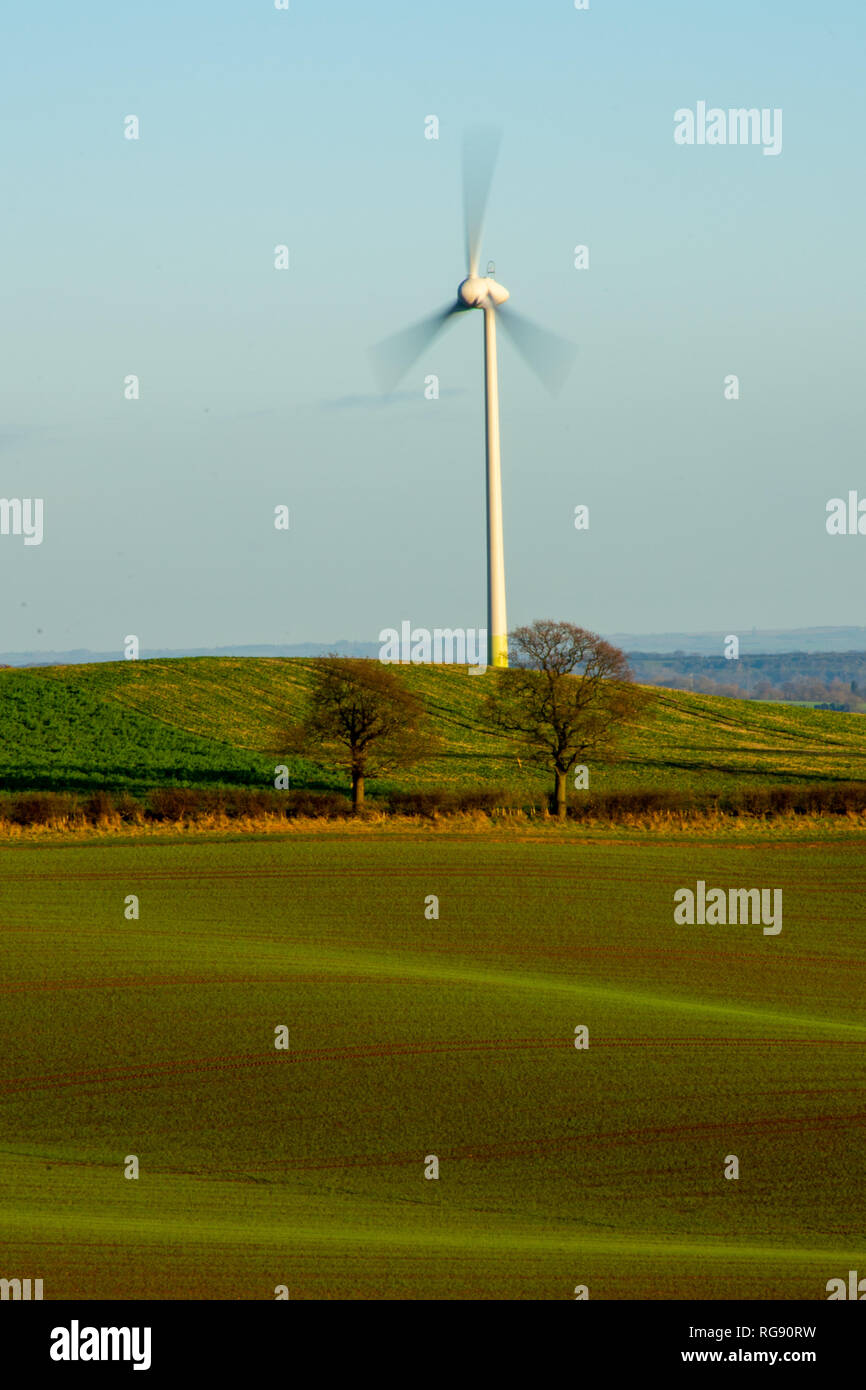 A lone wind turbine on a cool but bright winters day. situated among the rolling hills of Nottinghamshires rural farmland. Nottingham, England. (2019) Stock Photo