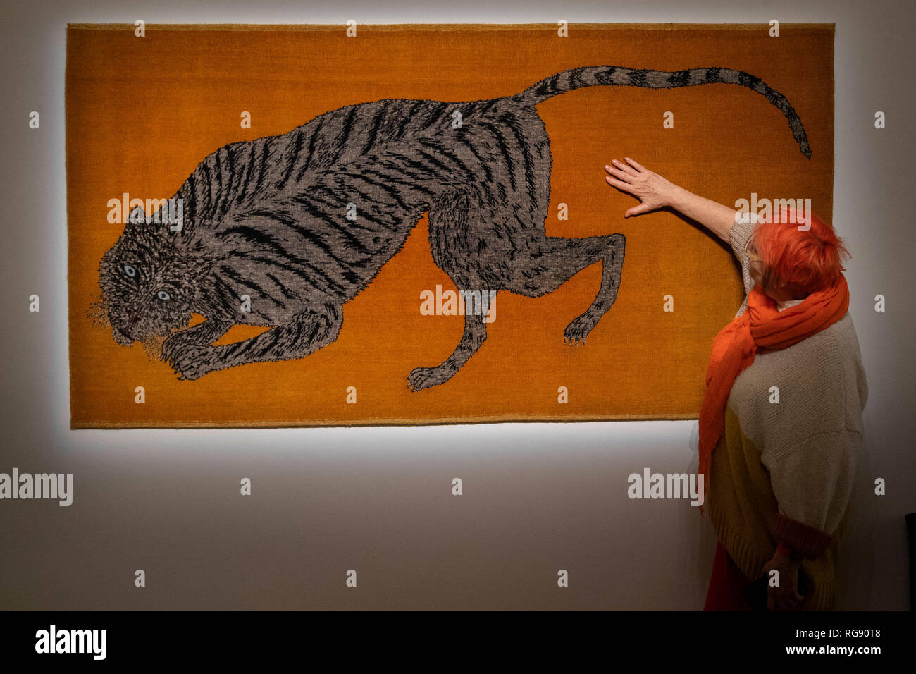 Curator Susie Allen looks at Pounce (2018-2019) by Kiki Smith at a London preview for Sotheby's Tomorrow's Tigers fundraising project which is designed to raise awareness and funds in support of the TX2 goal – a global commitment to double tiger numbers in the wild by 2022. Stock Photo
