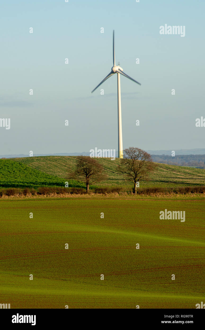 A lone wind turbine on a cool but bright winters day. situated among the rolling hills of Nottinghamshires rural farmland. Nottingham, England. (2019) Stock Photo