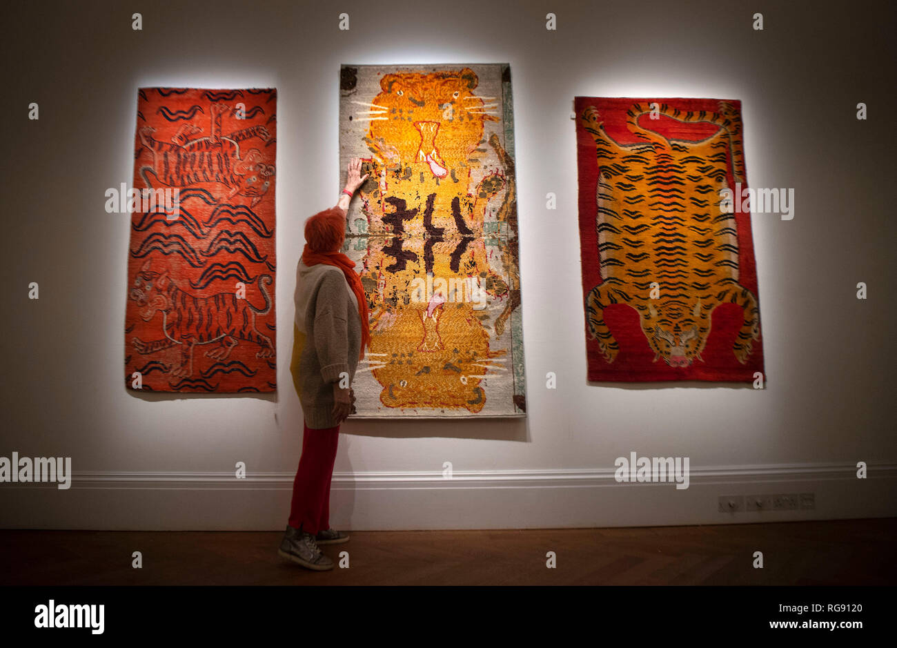 Orange Double Tigers (c1900 - 1950) by Tamie Cornwall Jones, Tiger Tiger (2018-2019) by Rose Wylie, and Red Flayed Tiger (c1900 - 1950) by Tamie Cornwall Jones, at a London preview for Sotheby's Tomorrow's Tigers fundraising project which is designed to raise awareness and funds in support of the TX2 goal – a global commitment to double tiger numbers in the wild by 2022. Stock Photo