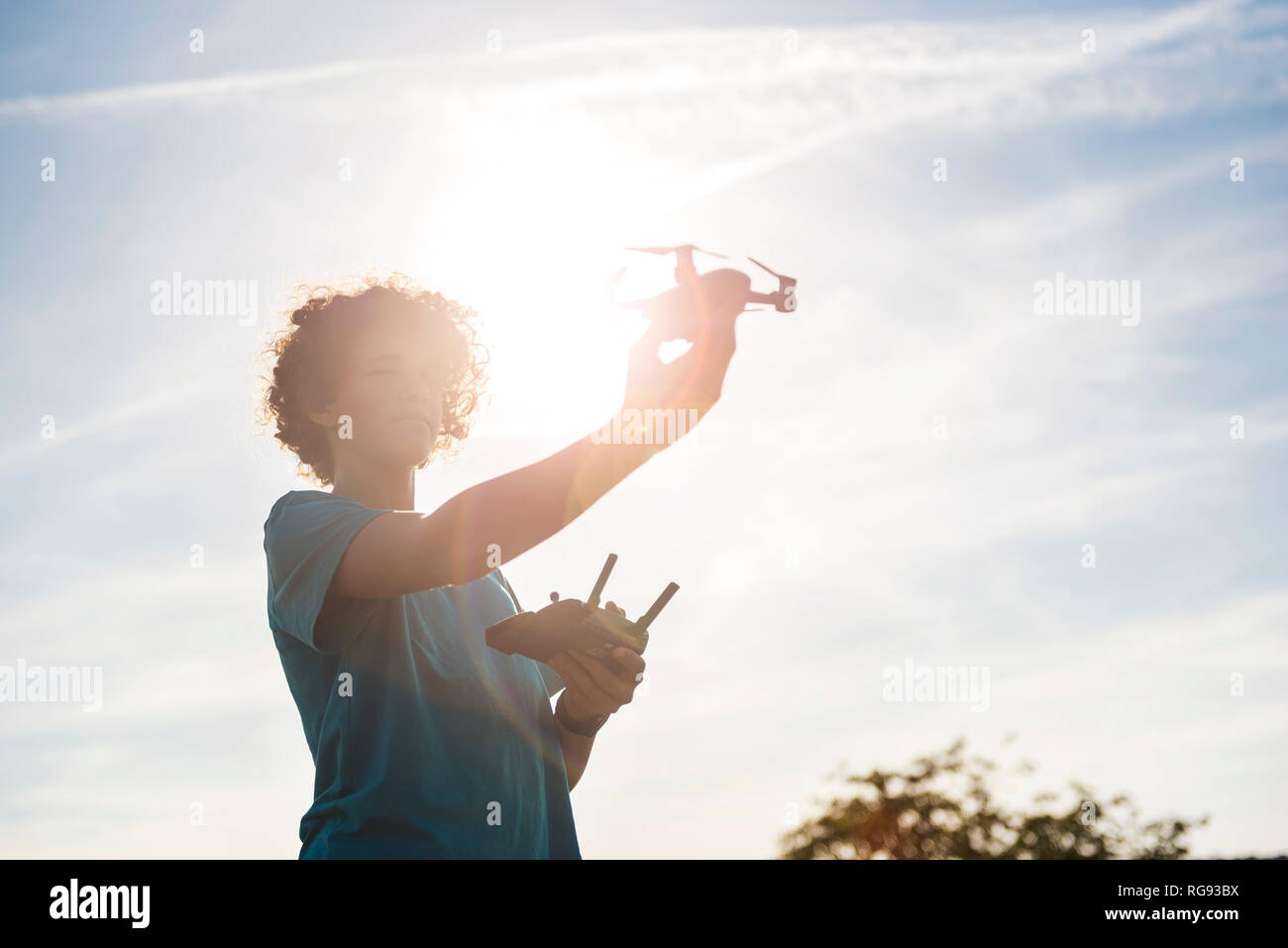 Boy flying a drone outdoors Stock Photo