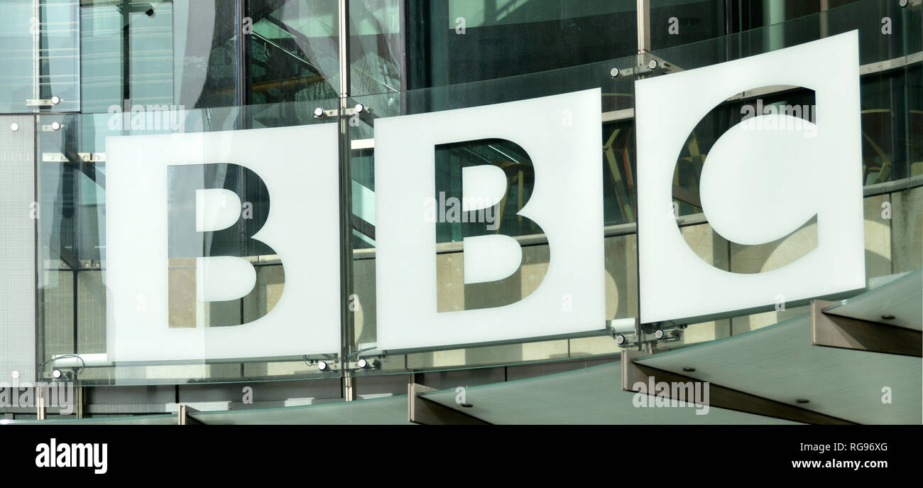 Close up BBC British Broadcasting Corporation sign logo & glass cladding on new modern HQ extension building at Broadcasting House London England UK Stock Photo