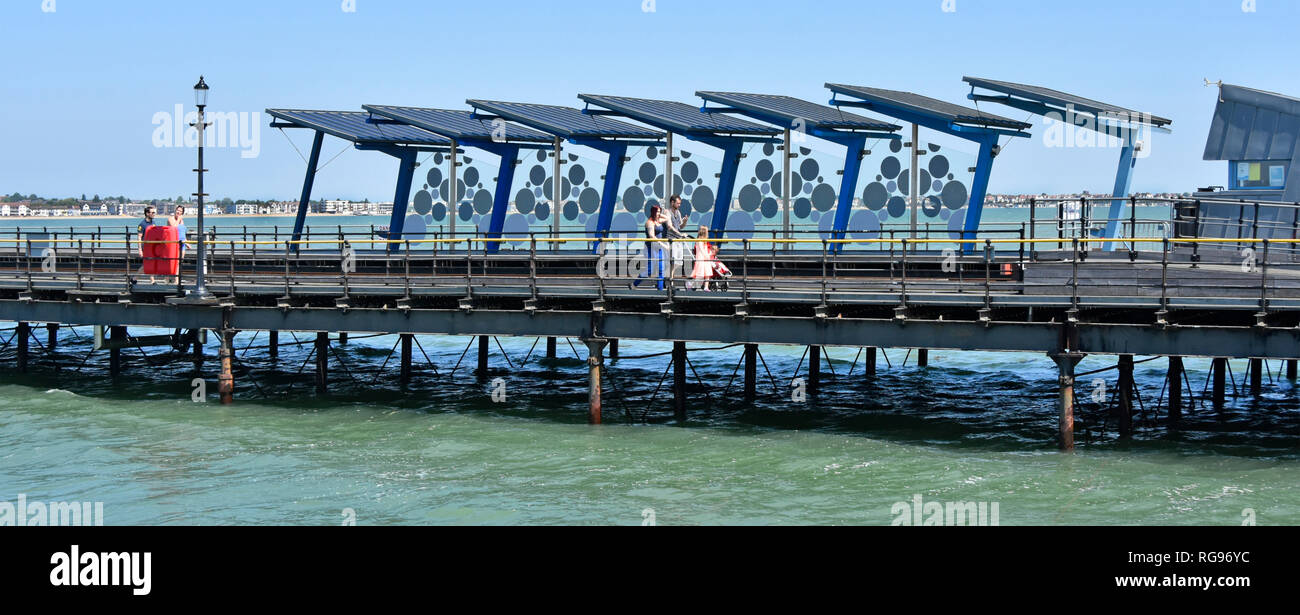 Thames Estuary Southend on Sea Pier Head with public transport train railway station &  people family walking 1.34 miles walk from Southend Essex UK Stock Photo