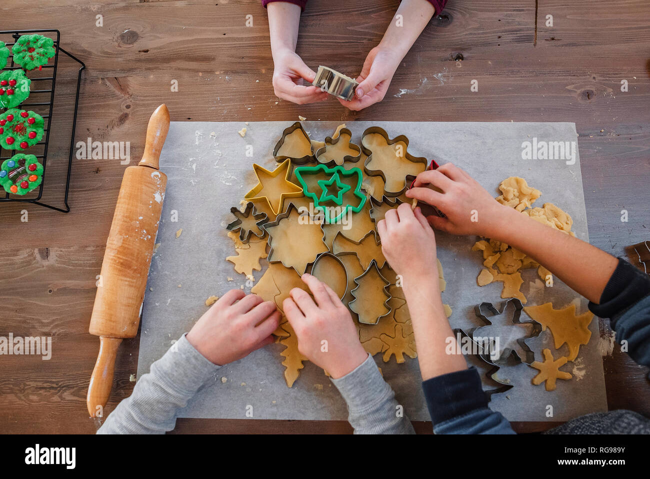 Overhead view of three children making Christmas cookies Stock Photo