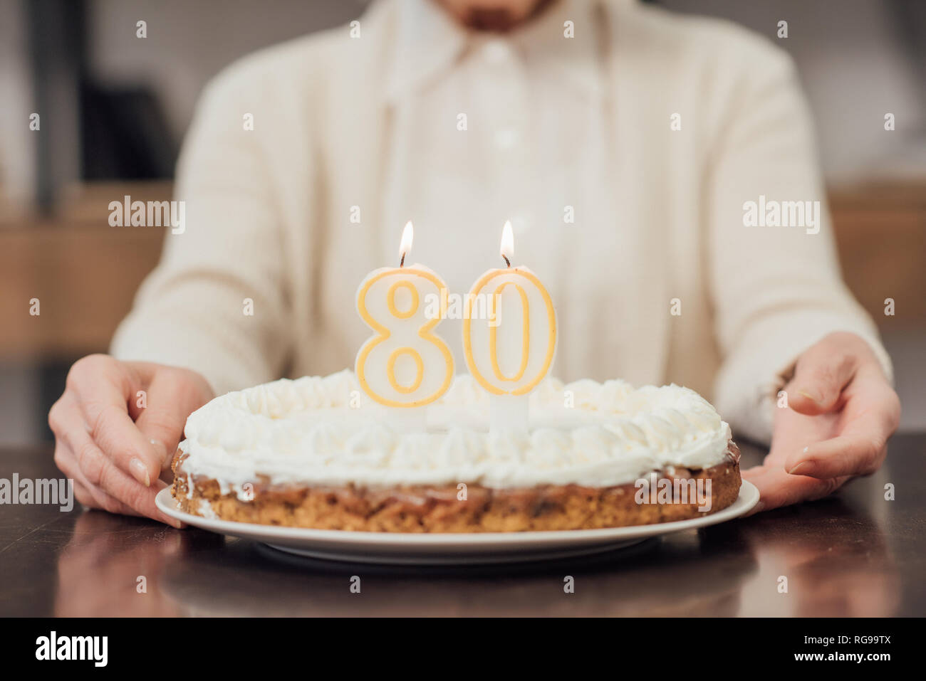 Old woman holding birthday cake hi-res stock photography and images - Alamy