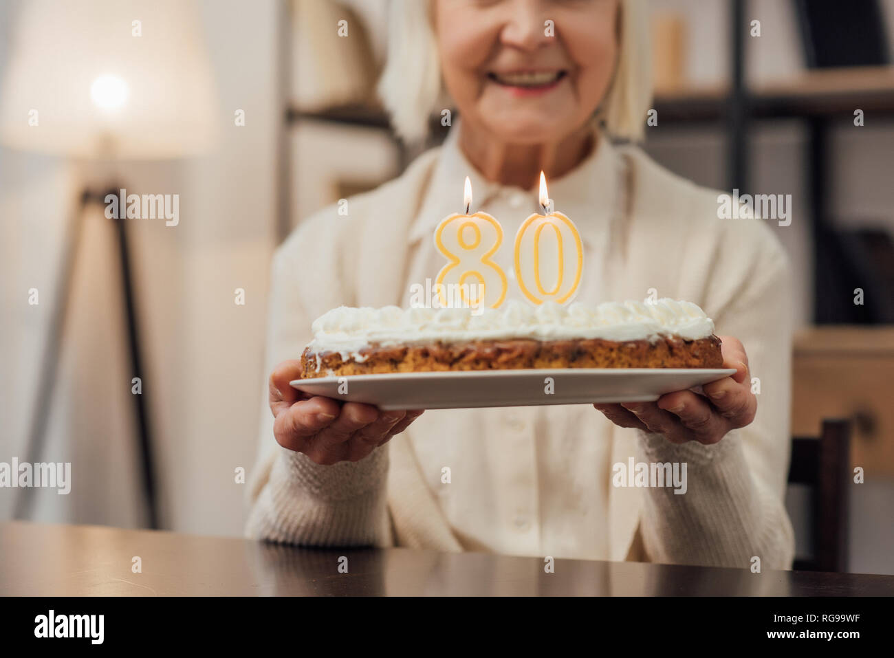 Old woman holding birthday cake hi-res stock photography and images - Alamy