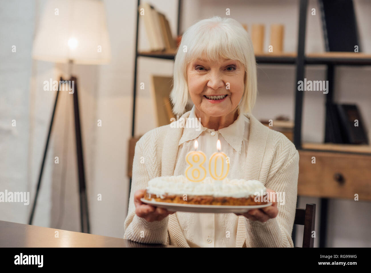 Old woman holding birthday cake hi-res stock photography and images - Alamy