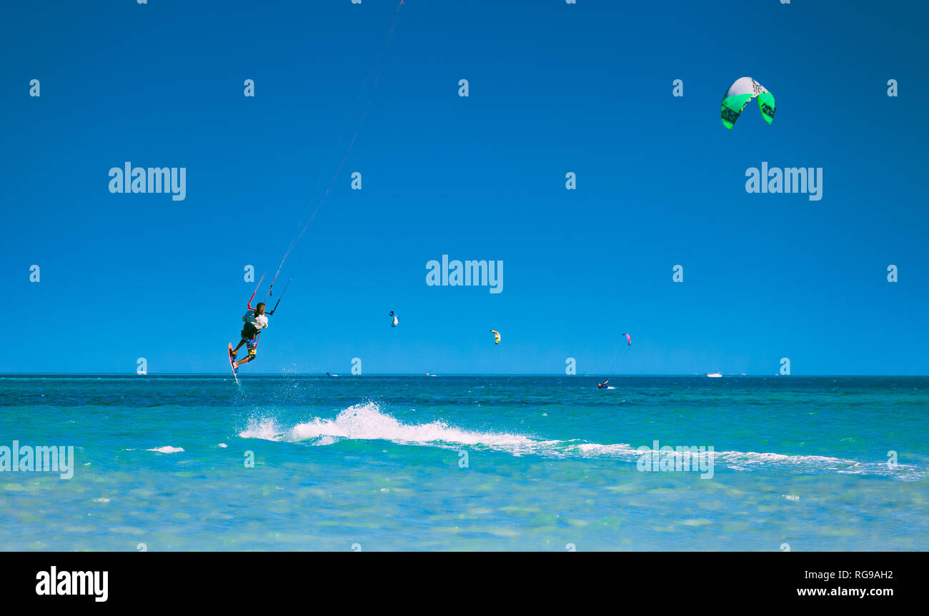 Egypt, Hurghada - 30 November, 2017: The kitesurfer soaring in the blue sky over the Red sea surface. Breathtaking marine scenery. The flight over the Stock Photo