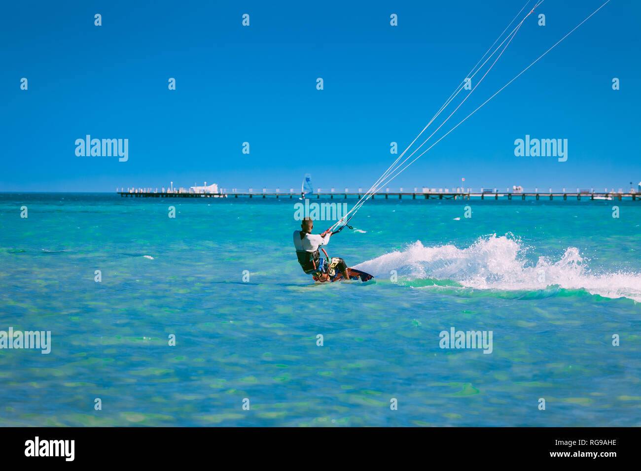 Egypt, Hurghada - 30 November, 2017: The kiter gliding over the Red sea waves. The back side. Breathtaking transparent turquoise water under the clear Stock Photo