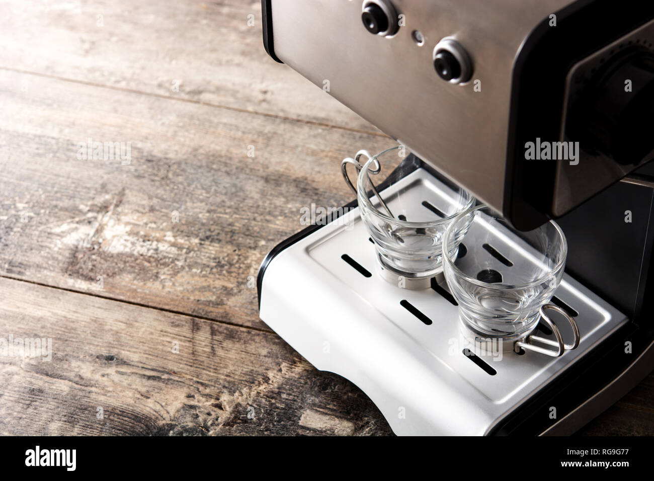 Espresso coffee machine with empty cup on wooden table Stock Photo