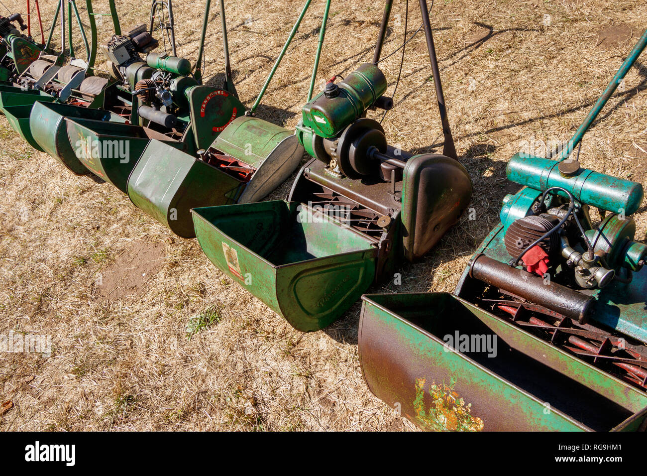 An assortment of petrol engine lawn mowers with cuttings collection boxes on display at an agricultural show in Norfolk UK. Stock Photo