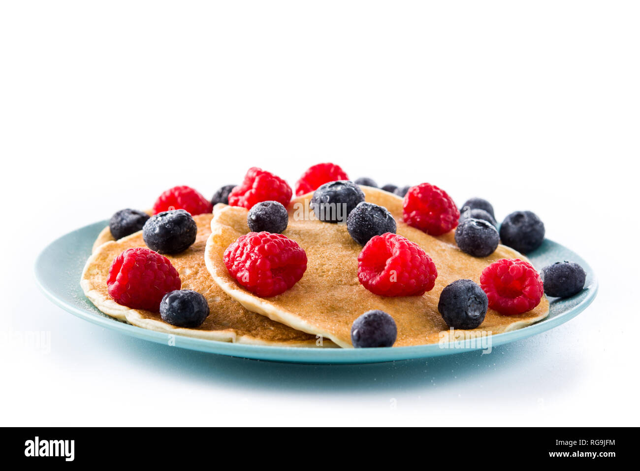 Pancakes with raspberries and blueberries isolated on white background ...