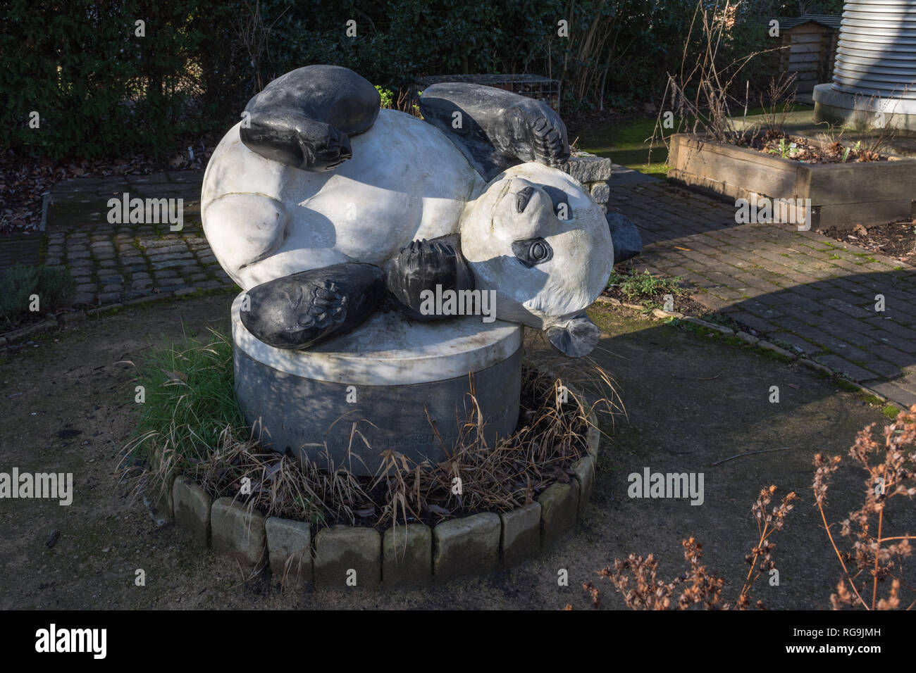 The Living Planet Centre, headquarters of the World Wildlife Fund (WWF) in Woking, Surrey, UK. Giant panda model, the WWF logo, in the garden outside. Stock Photo