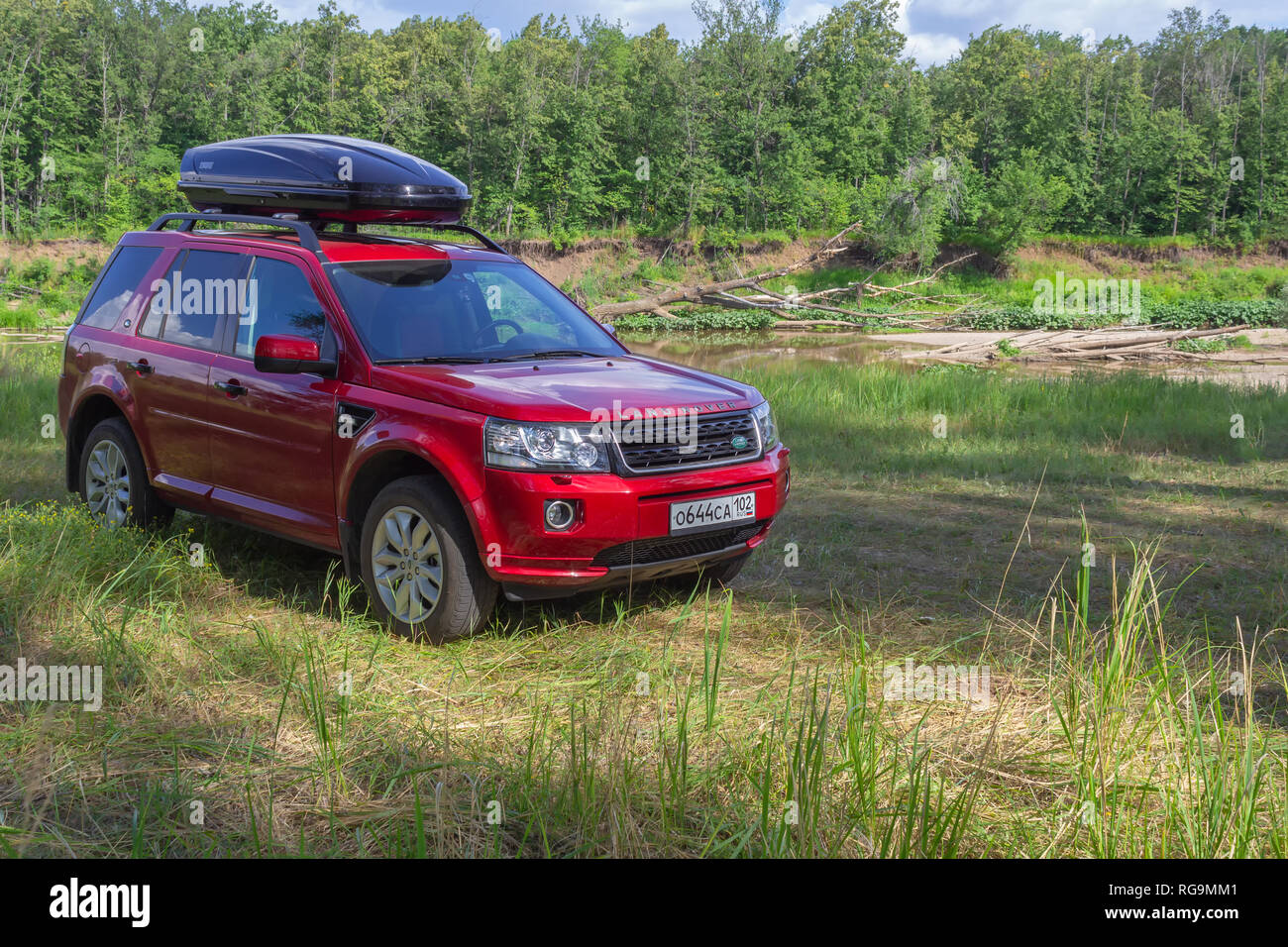 SUV LAND ROVER FREELANDER 2 and TULE autoboxing in the woods on the river bank, a car for traveling. Stock Photo