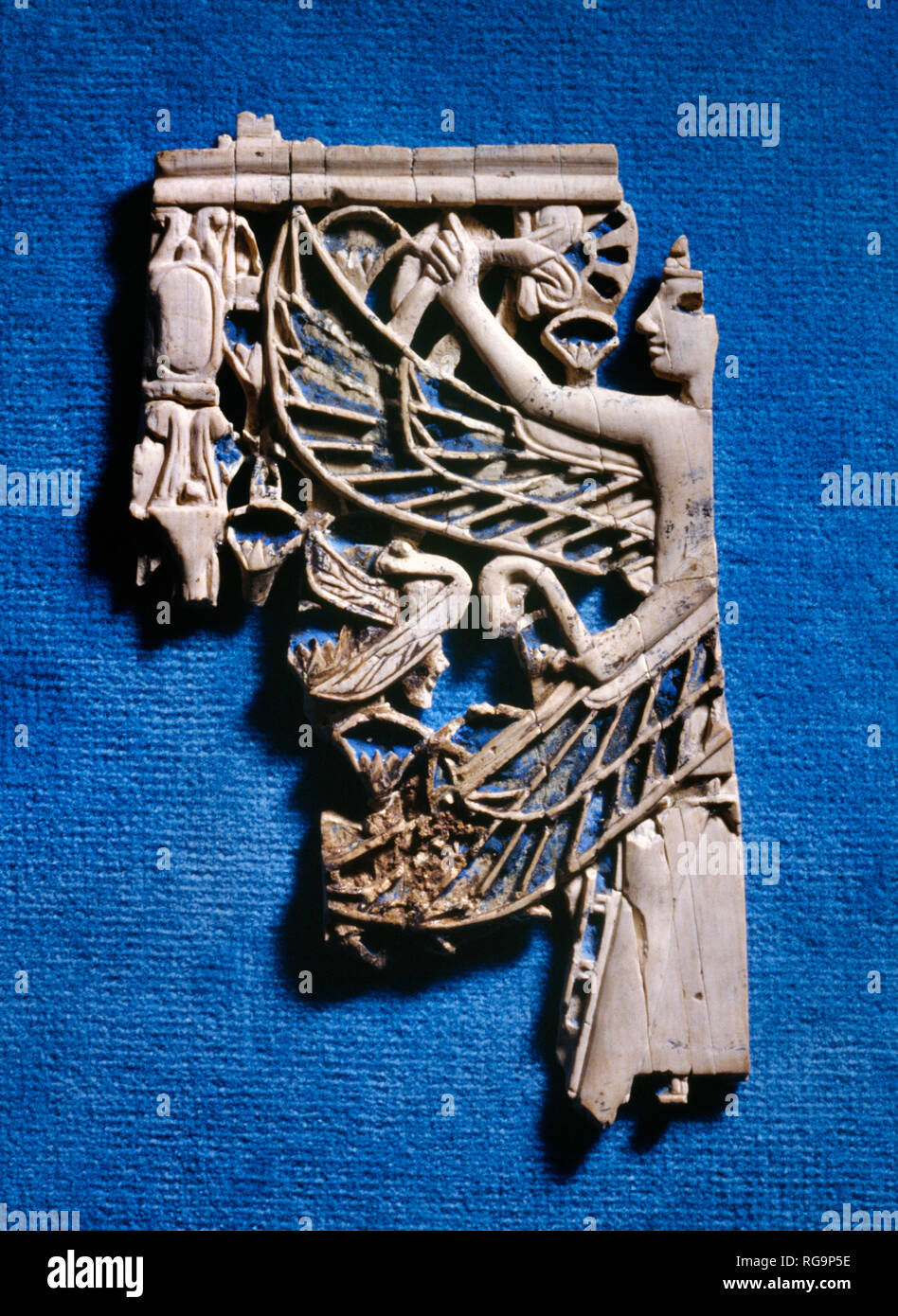 Winged male figure: Nimrud Ivory from Room SW37 Fort Shalmaneser within the Assyrian city of Nimrud, Iraq, photographed in the Iraq Museum, Baghdad. Stock Photo