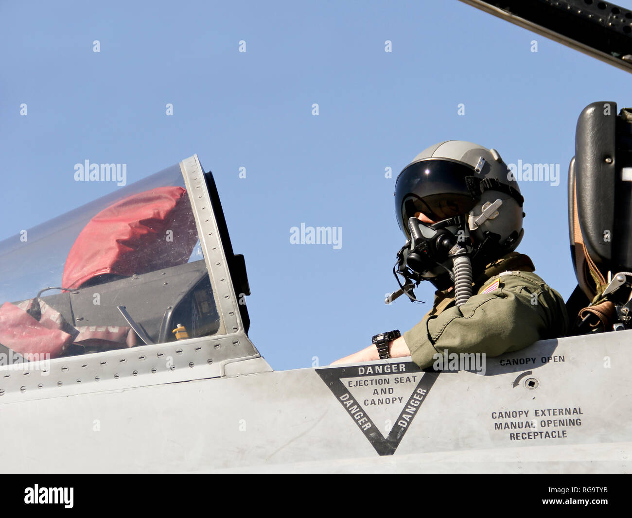 United States Navy Fighter Pilot in full gear sitting in a jet Stock Photo