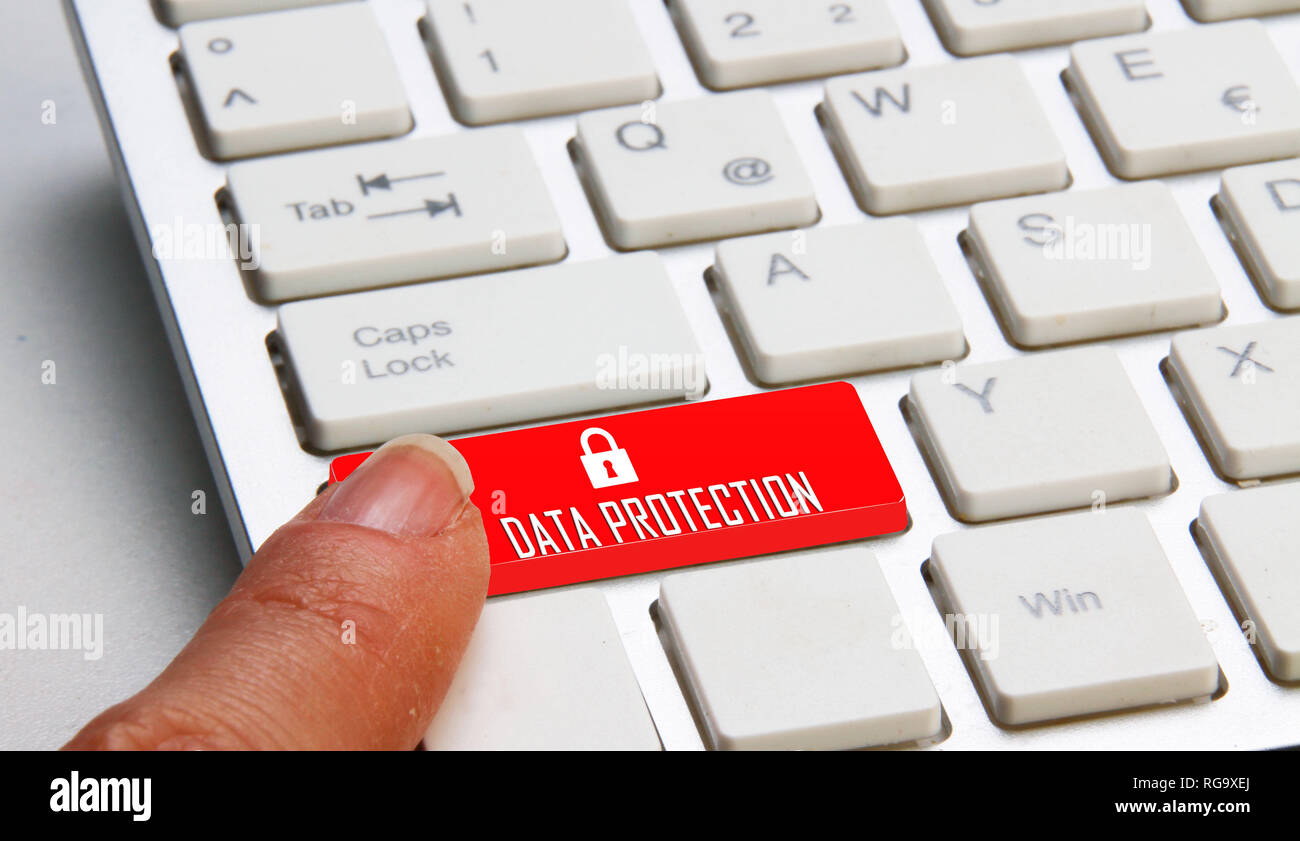 finger on a computer keyboard with Data protection written on it Stock Photo