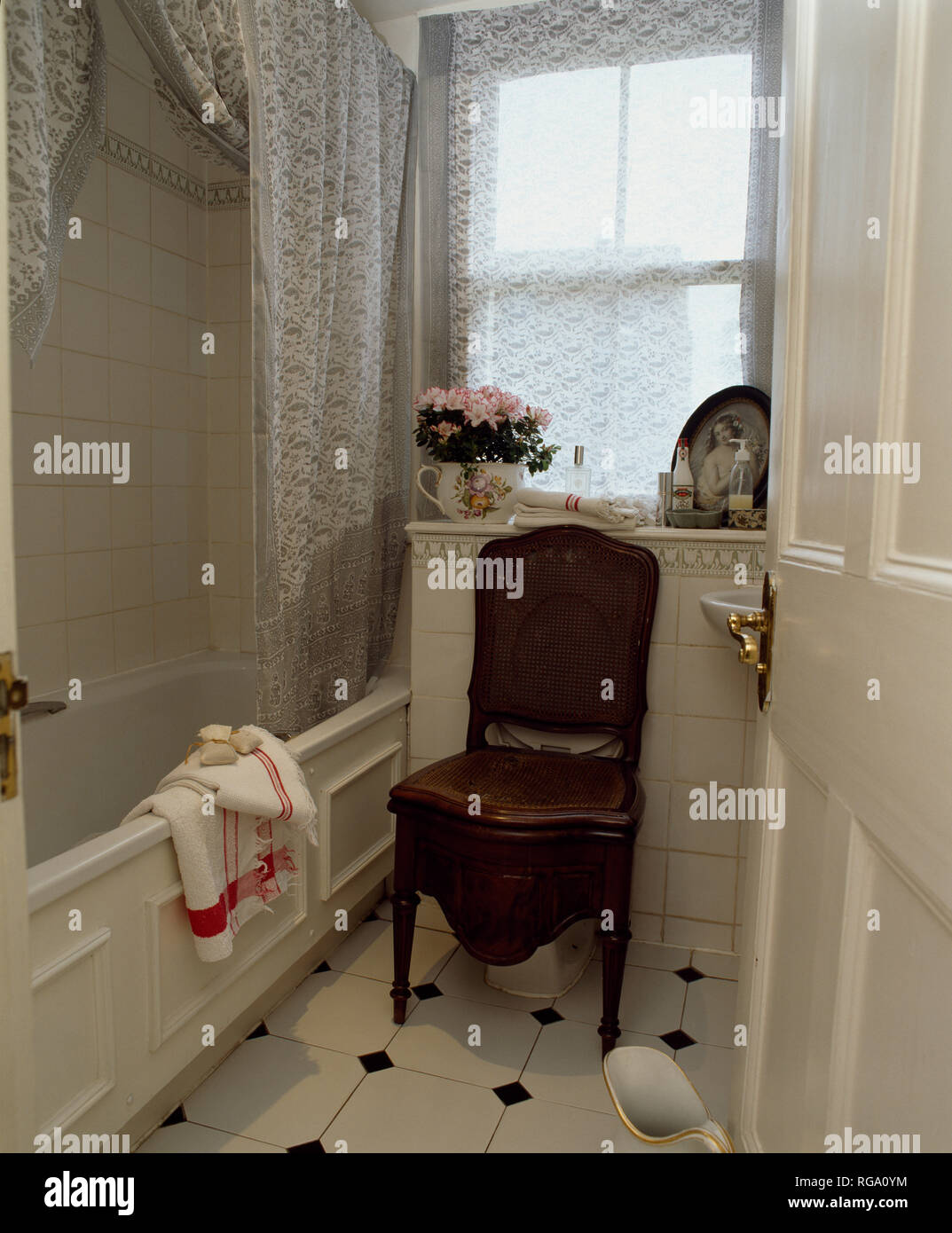 Antique commode in old fashioned grey and white bathroom Stock Photo ...