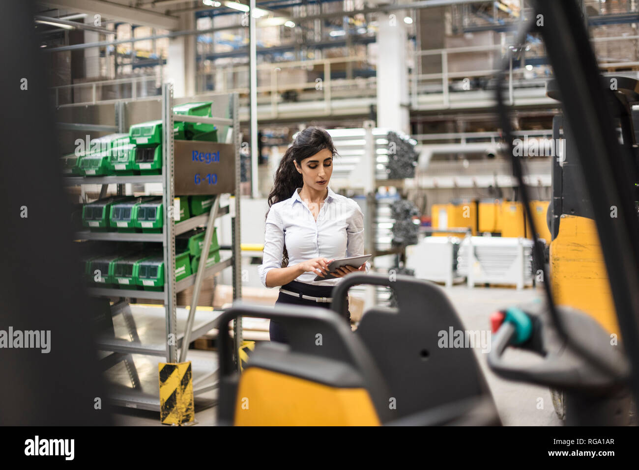Woman using tablet in factory shop floor Stock Photo Alamy