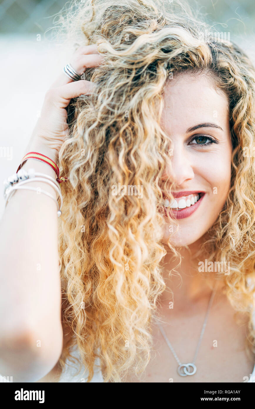 Portrait of young woman with blond curly hair Stock Photo