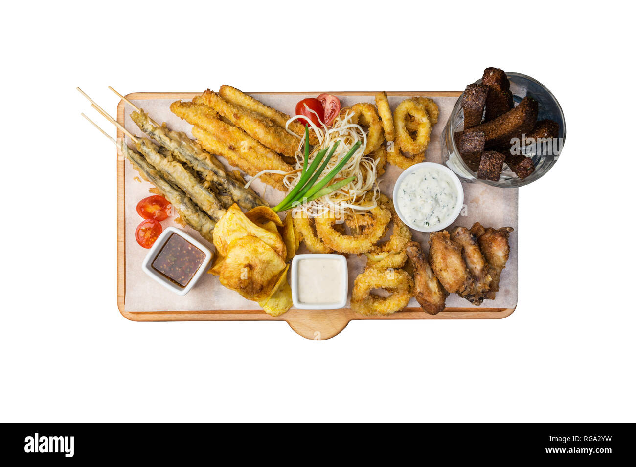 Beer snacks set. Fish set served on cutting board with the mugs, isolated on the white background. Stock Photo
