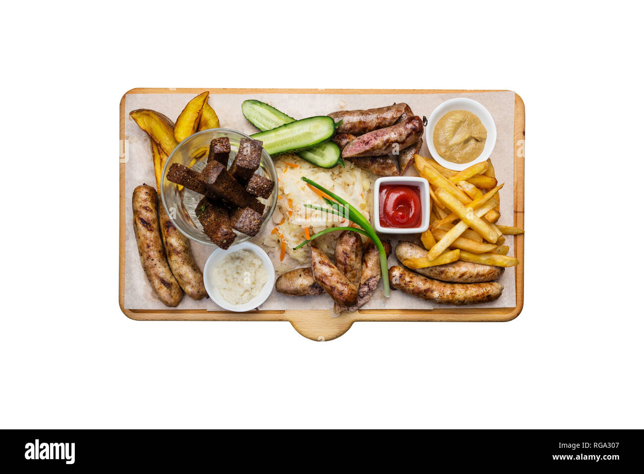 Beer snacks set. Grilled sausages and french fries with tomato and BBQ sauce, served on cutting board. Stock Photo