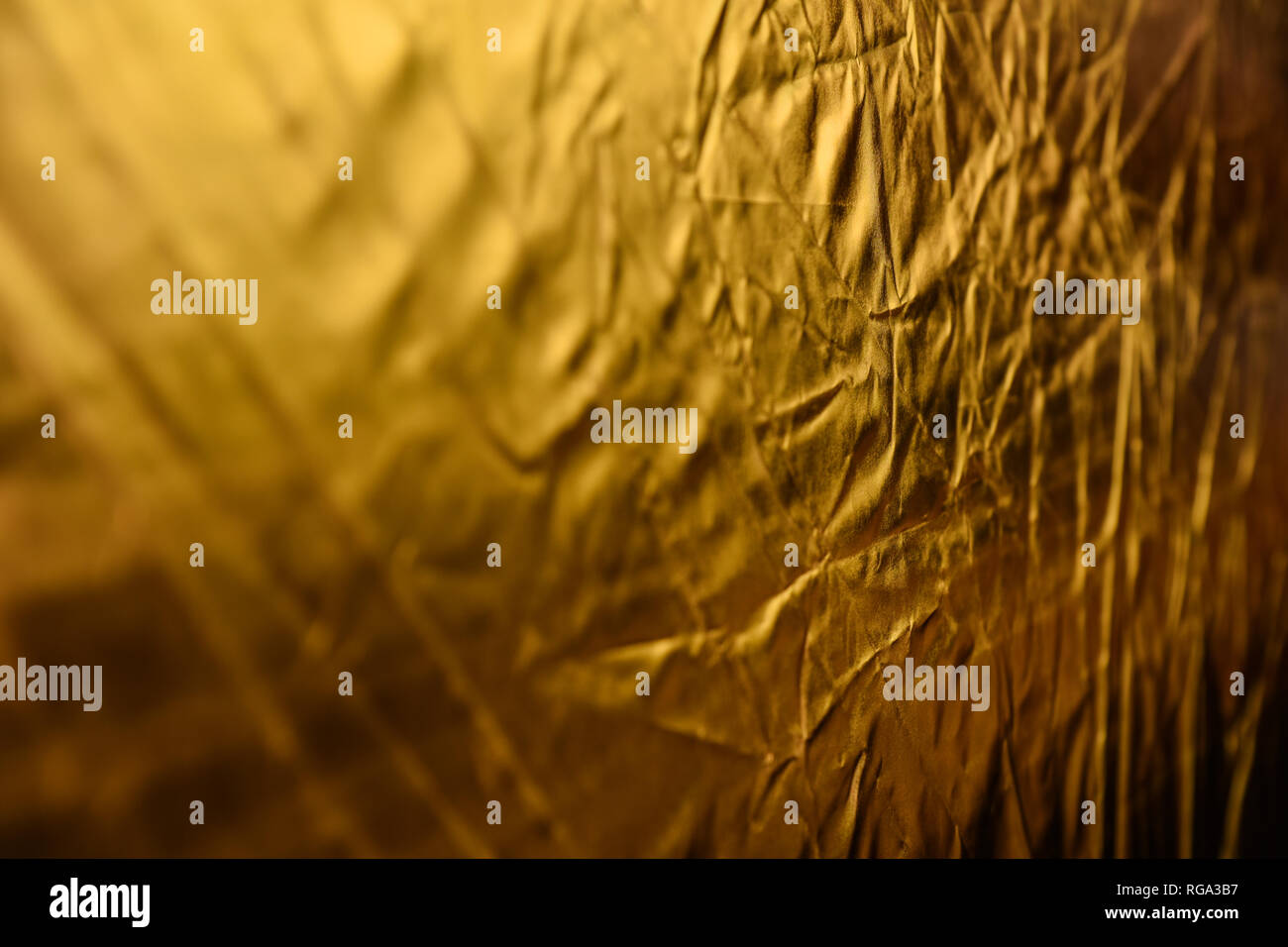 gold dented background. reflector macro. the backdrop for postcards. Stock Photo