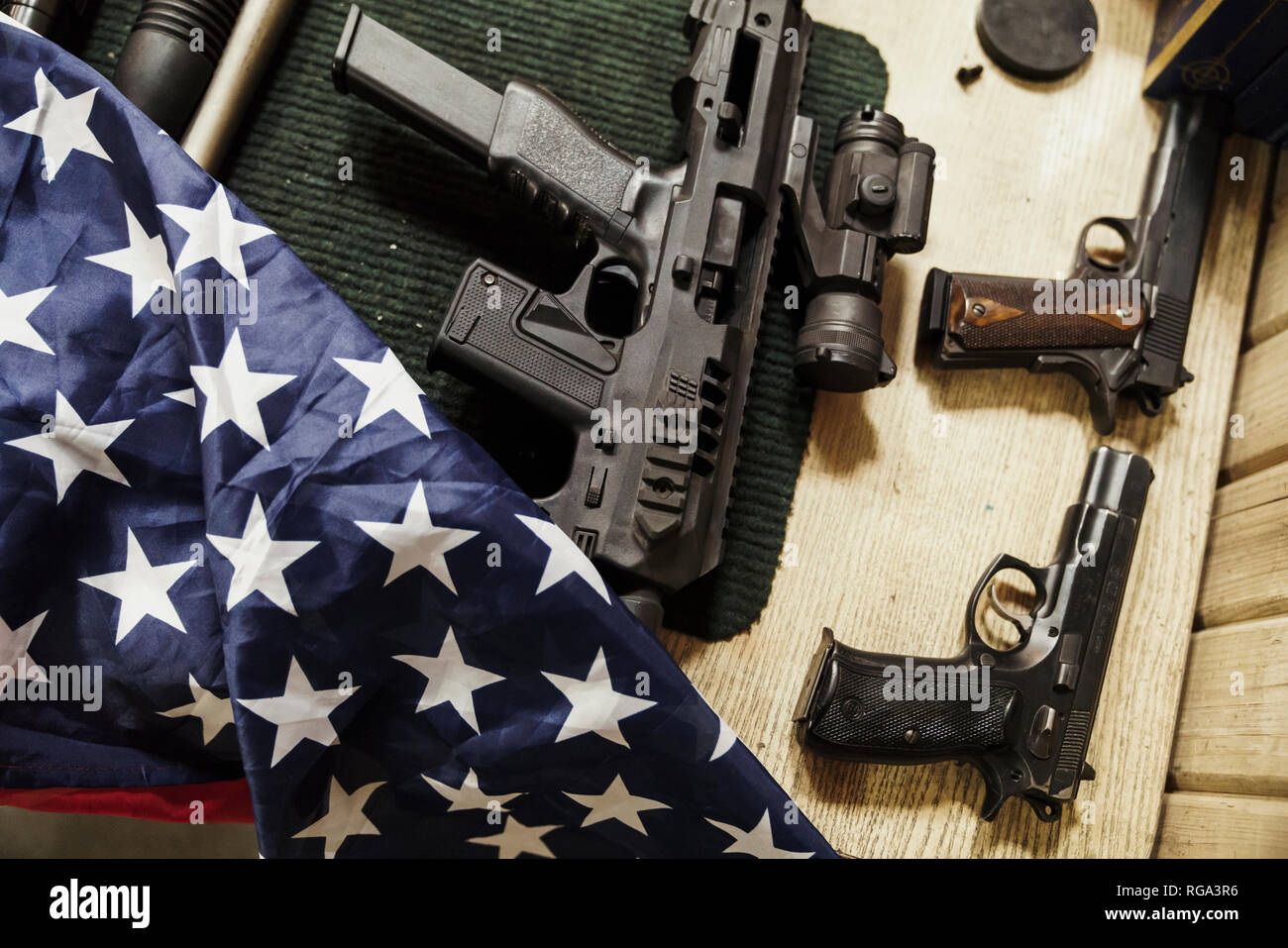 Rifles, guns and American flag on table Stock Photo