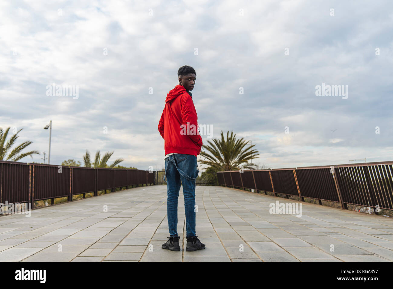 Young black man standing hi-res stock photography and images - Alamy
