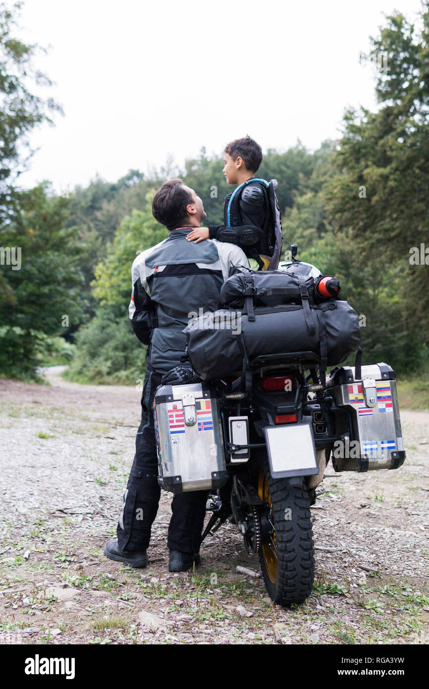 Father and son having a break during a motorbike trip Stock Photo