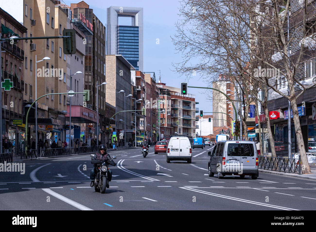 Biker along the traditional street of Calle Bravo Murillo with the Torre Cepsa, Madrid, Spain Stock Photo